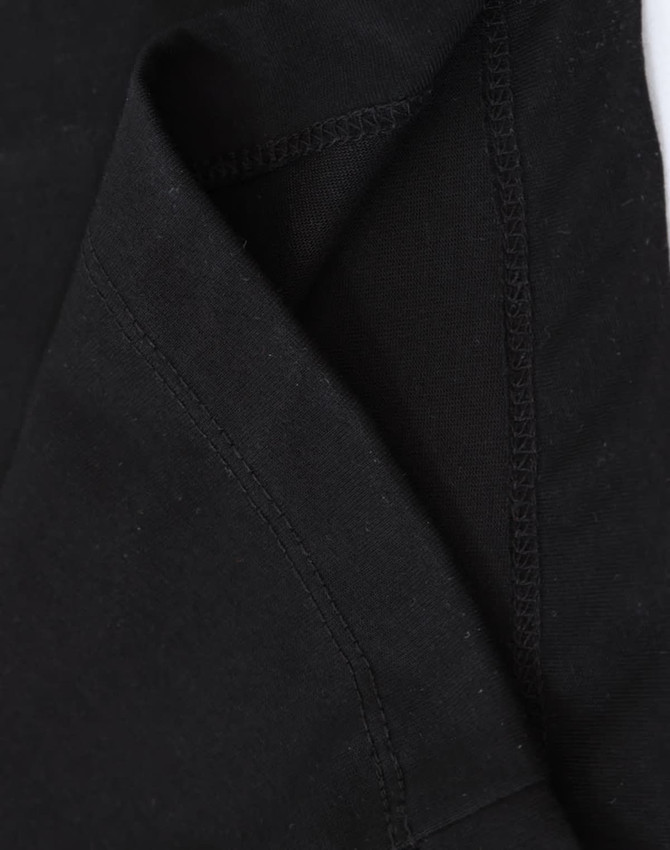 A close-up of a black premium cotton long-sleeve tee shirt, highlighting the stitching and fabric texture.