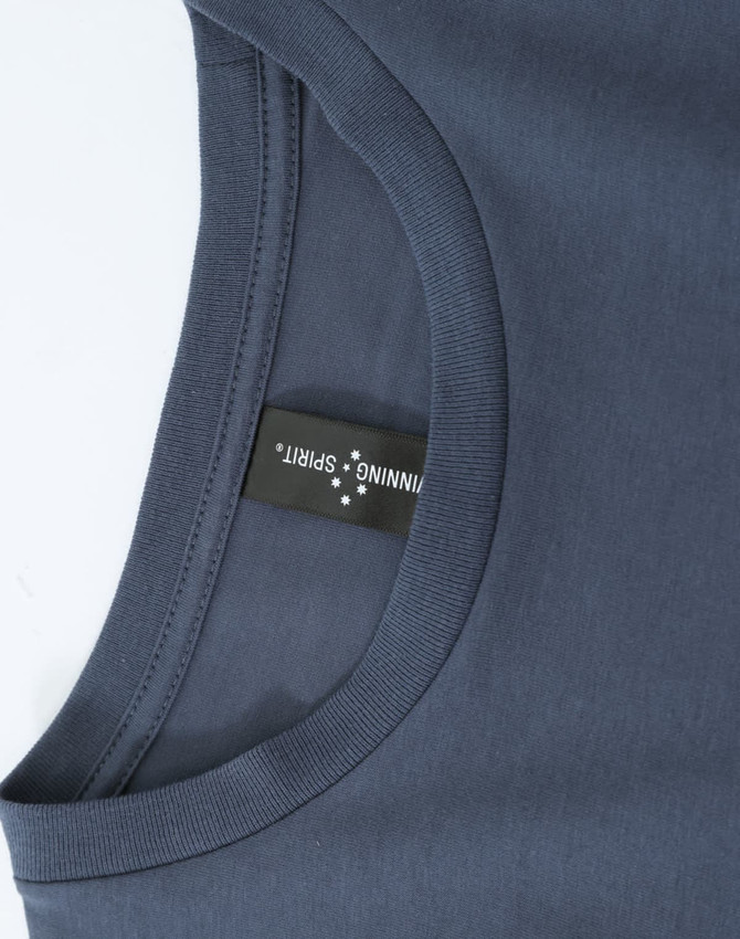 A close-up of a dark grey ladies' long-sleeve cotton tee shirt with a tag and a rounded neckline.