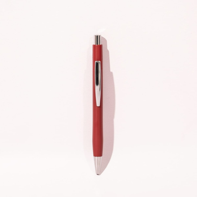 A red ballpoint pen with a silver clip, featuring a sleek design and a shiny finish.