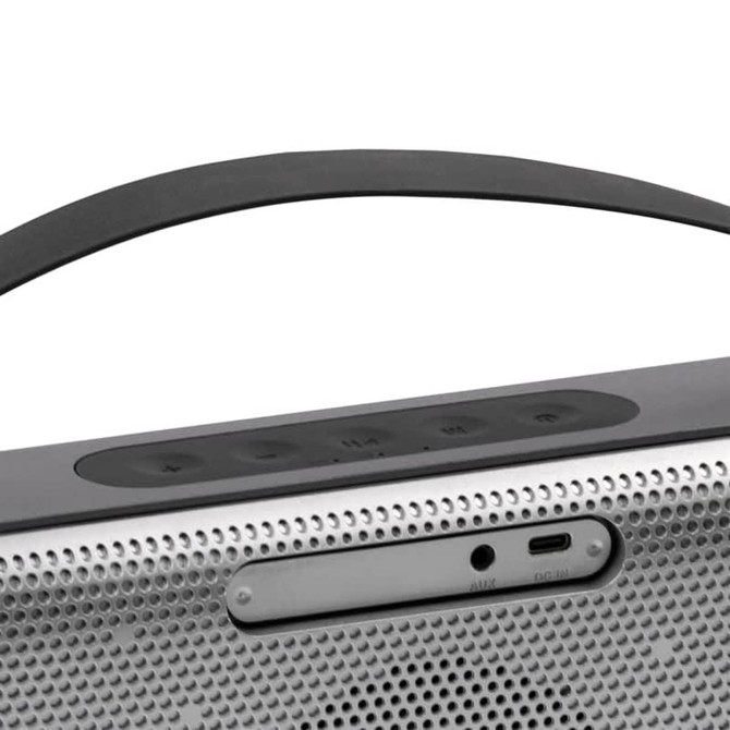 A wireless speaker in grey with a sleek design, featuring control buttons and a logo on the front.