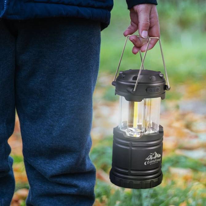 A COB lantern with a durable design, featuring a clear casing and a handle for easy carrying.