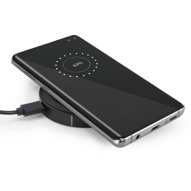 A sleek black wireless charger with a smartphone placed on top, displaying a charging status of 63%.