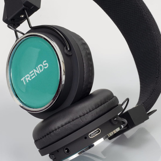 Bluetooth headphones with a teal ear cup, black padding, and an adjustable band. Features a logo on the side.