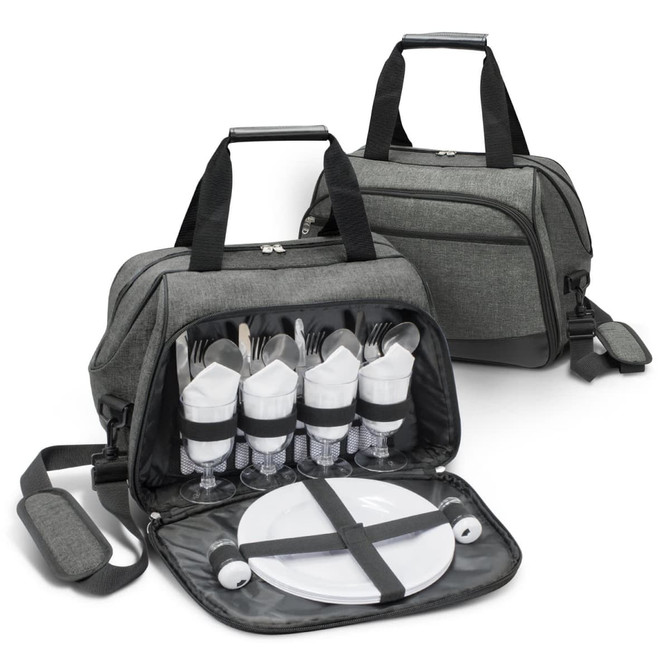 A grey picnic bag with cutlery, glasses, and plates neatly arranged inside. It has two handles and an adjustable strap.
