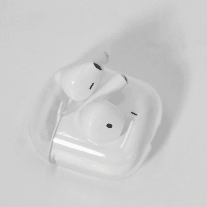 White noise cancellation earbuds in a clear case, featuring a simple design and a compact size.