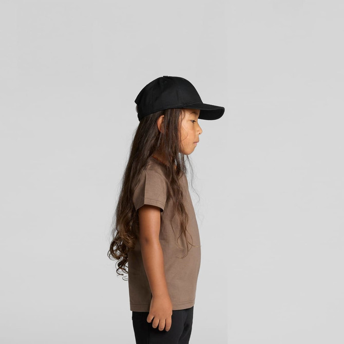 A child wearing a brown staple tee and a black cap, shown in profile against a plain background.
