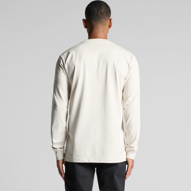 A man wearing a long sleeve cream t-shirt, viewed from the back. The shirt has a simple design and no visible logos.