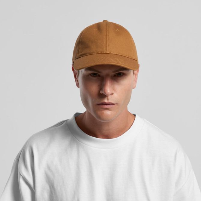 A brown cap with a structured fit, featuring a logo on the front, worn by a model in a white shirt.