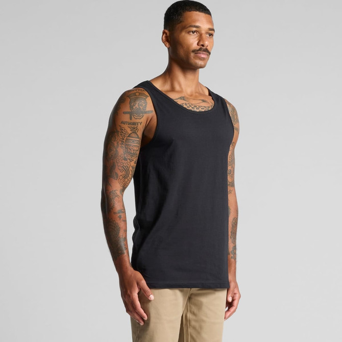 A black singlet featuring a classic tank style, displayed on a tattooed male model against a neutral background.