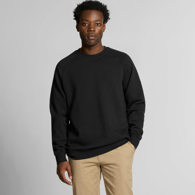 A black jumper sweater worn by a man, featuring a simple design and a logo on the chest.