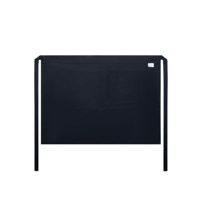 A black half apron featuring a front pocket and ties at the waist. It includes a branding label.