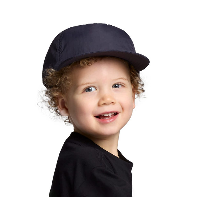 A navy cap designed for kids, featuring a curved brim and a logo on the side, worn by a smiling child.
