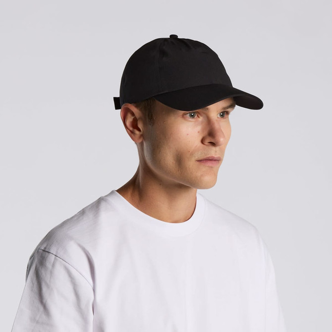 A black cap on a model wearing a white t-shirt, featuring a branding logo.