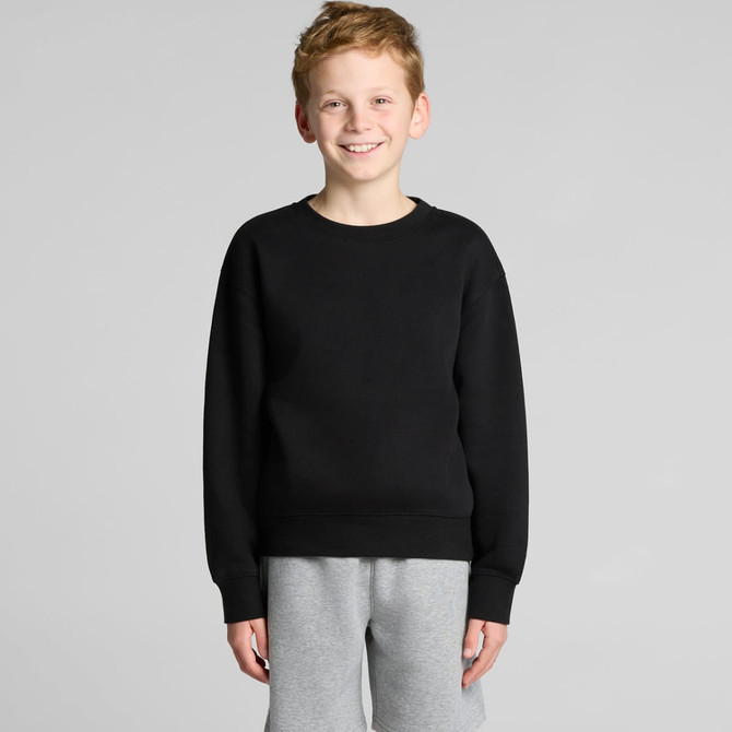 A black jumper featuring a round neckline and long sleeves, worn by a smiling boy with light brown hair.