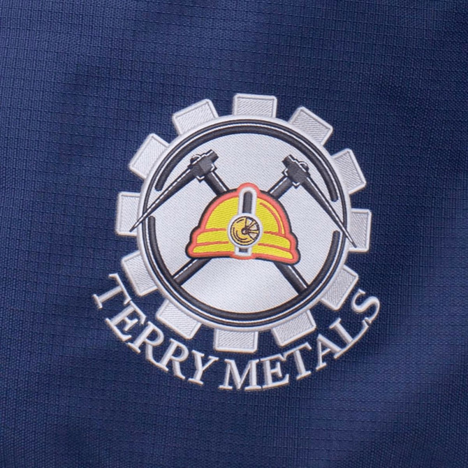 A navy fabric with an embroidered logo featuring a hard hat, crossed hammers, and the text "Terry Metals."