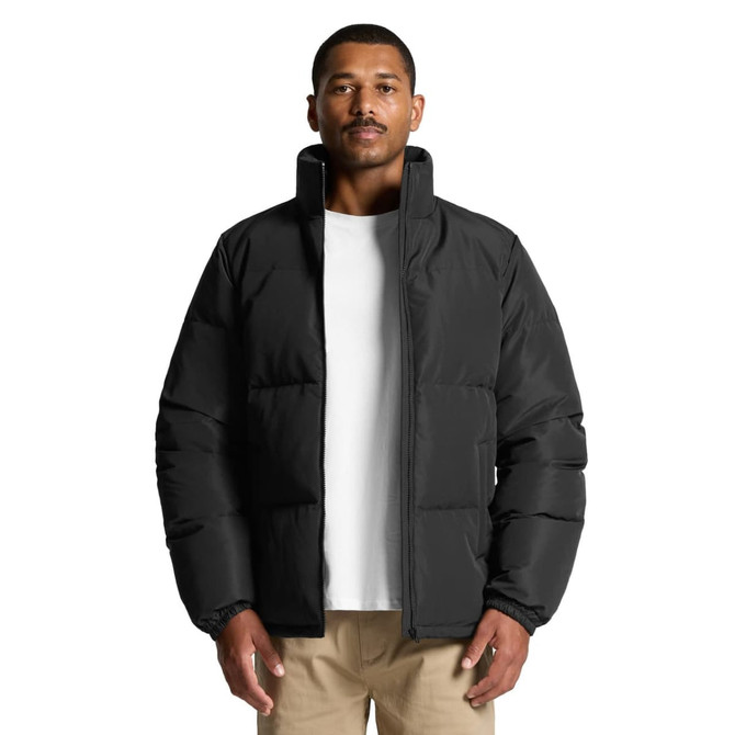 A puffer jacket in black, featuring a high collar and a relaxed fit, displayed on a model.