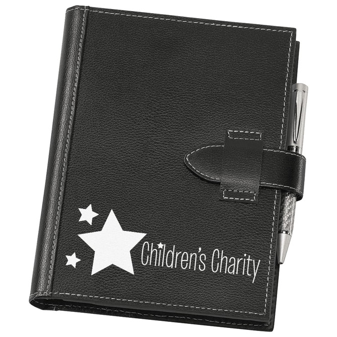A5 journal cover in black faux leather, featuring a locking strap and a pen, with star graphics and a logo.