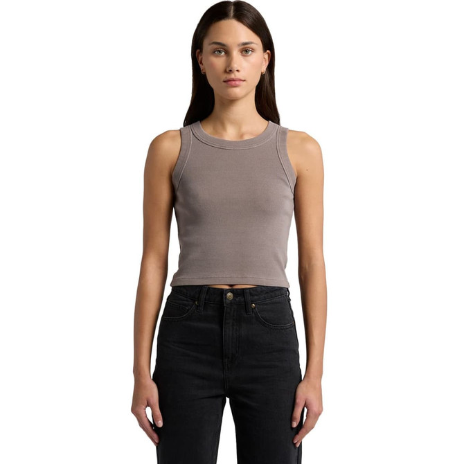 A model wearing a faded organic rib crop tank in a muted grey colour, paired with black high-waisted jeans.