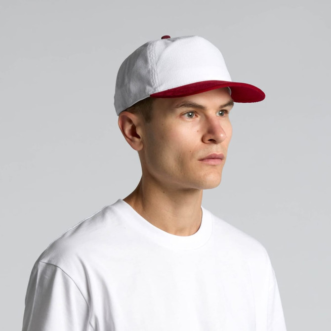 A two-tone cap featuring a white crown and a red peak, worn by a model in a plain white t-shirt.