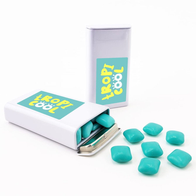 A pack of turquoise chewy mints, with some mints spilled out, in a silver tin featuring a logo.