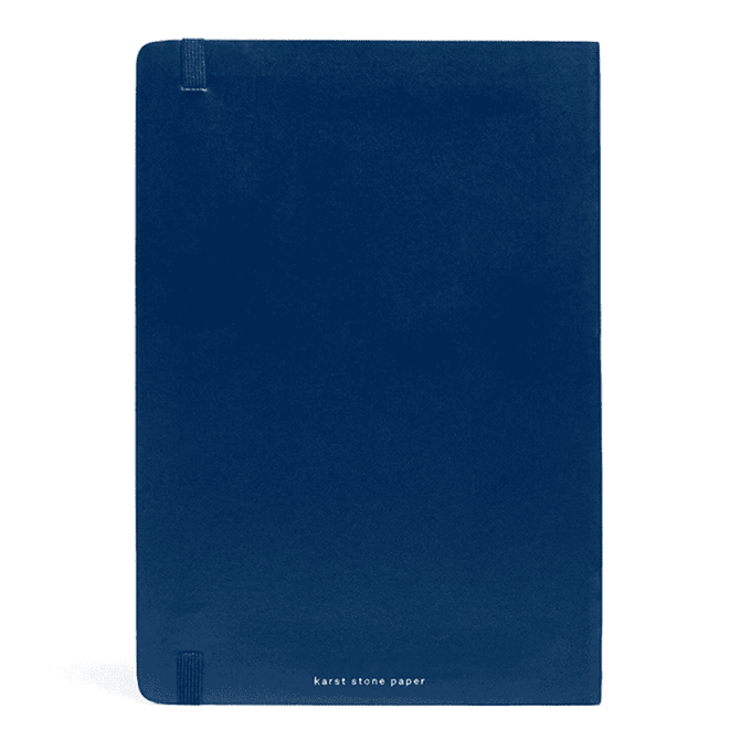 A navy softcover notebook featuring a smooth finish and an understated logo at the bottom.