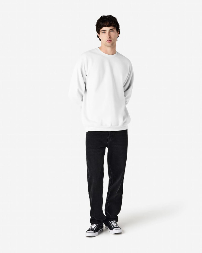 A white Gildan Softstyle adult sweatshirt displayed on a model, paired with black jeans and sneakers.