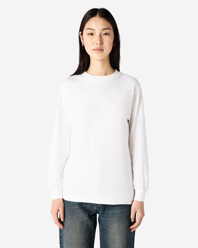 A heavyweight cotton unisex long sleeve T-shirt in white, displayed on a model with straight black hair.