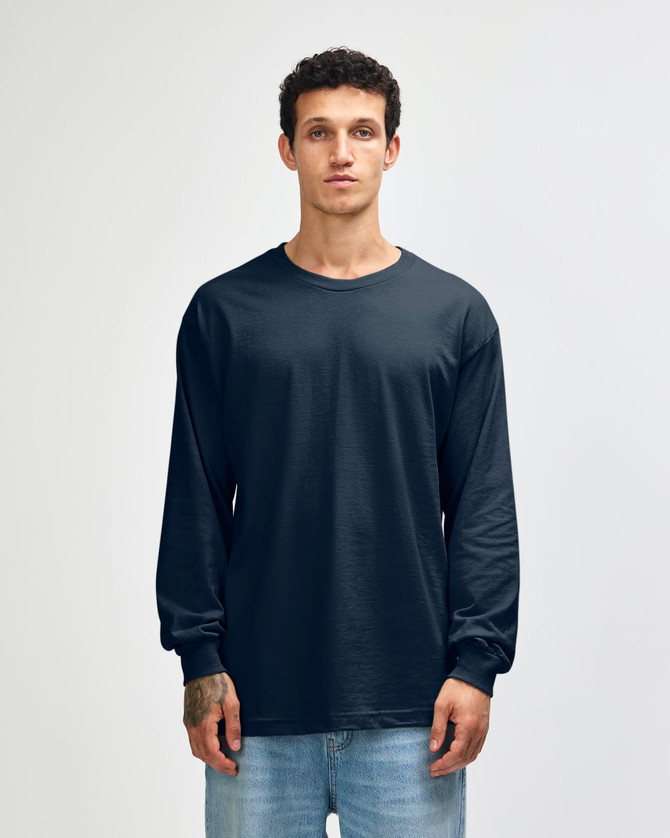 A navy unisex long sleeve T-shirt made from heavyweight cotton, displayed on a model against a plain background.