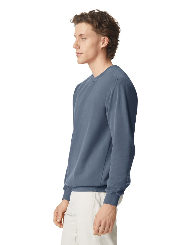 A crewneck sweatshirt in a shade of blue, featuring long sleeves and a logo. 