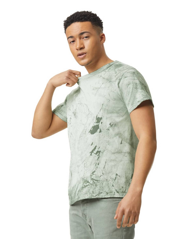 A heavyweight t-shirt in a green marble pattern, featuring a logo, worn by a model.