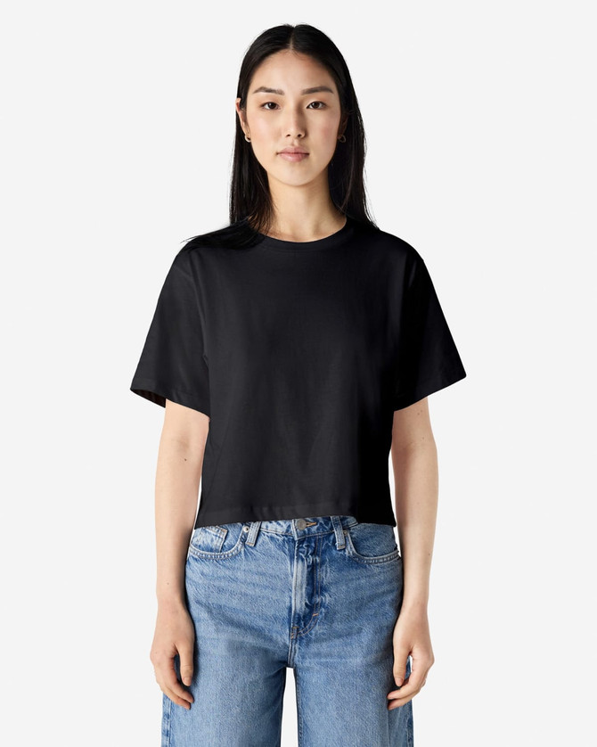 A black women's boxy t-shirt displayed on a model, featuring a relaxed fit and short sleeves.