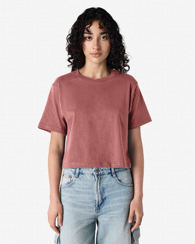 A women's boxy T-shirt in rose colour, featuring short sleeves and a relaxed fit, with a logo on the brand.