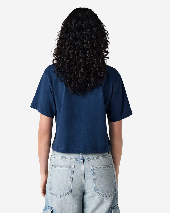 A navy blue women's boxy T-shirt featuring a loose fit, viewed from the back. The model wears light blue cargo pants.