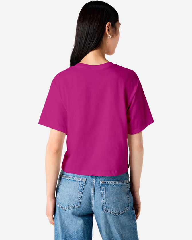 A women's fine jersey boxy T-shirt in magenta colour, featuring a plain back design. The model wears denim jeans.