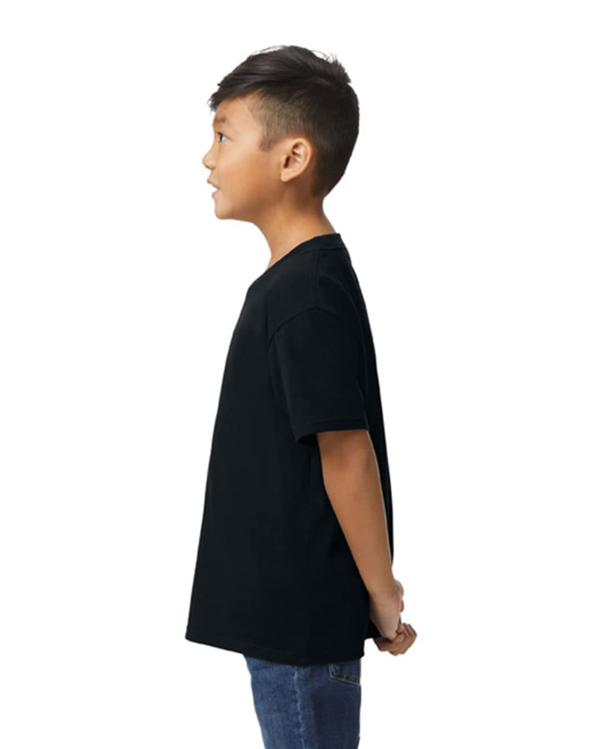 A black Gildan Softstyle youth midweight T-shirt displayed on a child, viewed from the side.