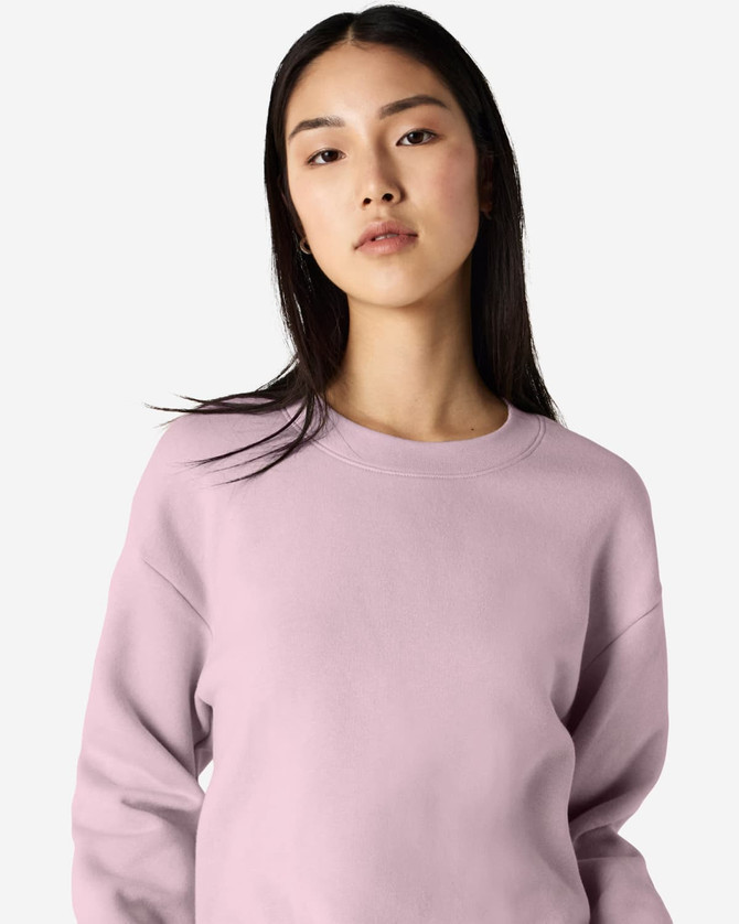 A unisex crewneck sweatshirt in a soft pink hue, featuring a casual design and a logo on the sleeve.
