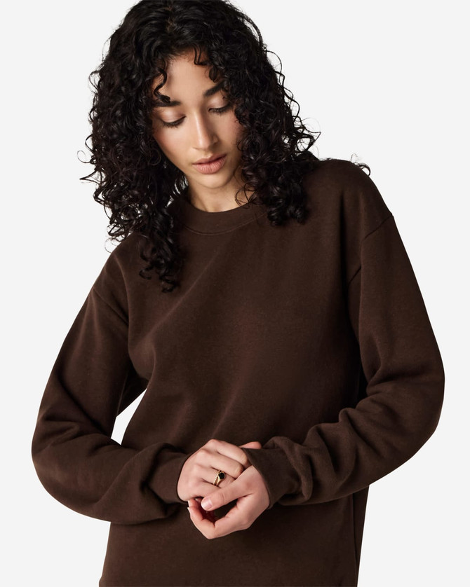 A unisex crewneck sweatshirt in a rich brown colour, featuring long sleeves and a standard fit. It has a logo.