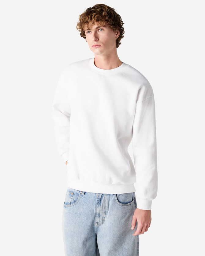 A white unisex crewneck sweatshirt with a relaxed fit, featuring long sleeves and a simple design.