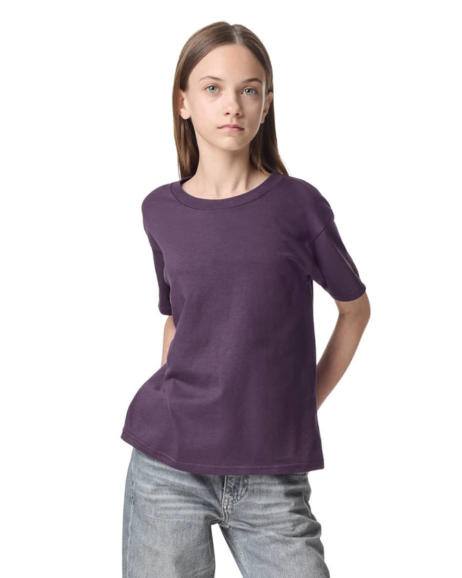 A purple youth t-shirt with short sleeves, featuring a brand logo.