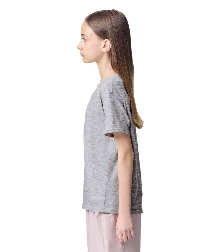 A grey youth T-shirt with short sleeves displayed on a model from the side. It includes a logo.