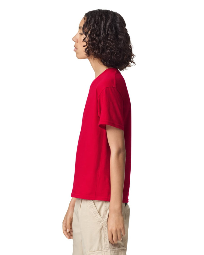 A red youth T-shirt in a side view, featuring short sleeves and a logo on the front.