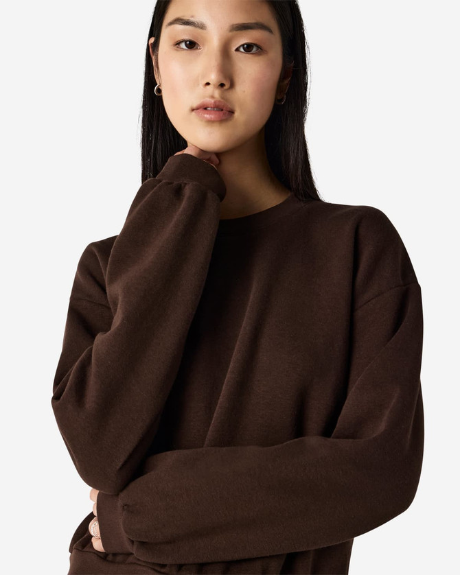 A brown women's crewneck sweatshirt with a relaxed fit, featuring long sleeves and a subtle logo.