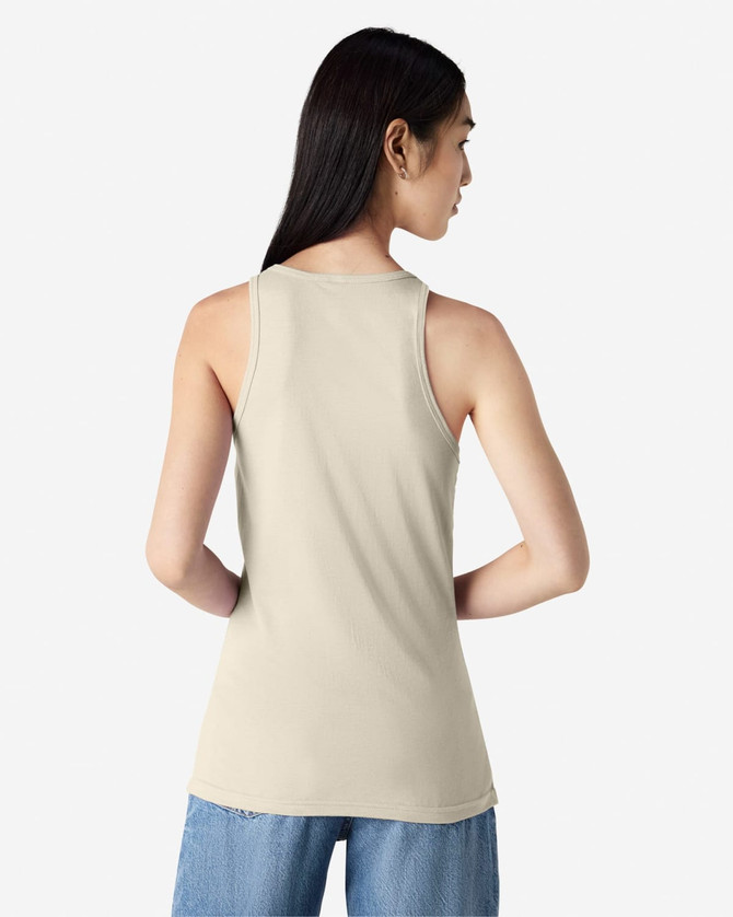 A women's racerneck tank in beige, featuring a logo on the back and a fitted silhouette.