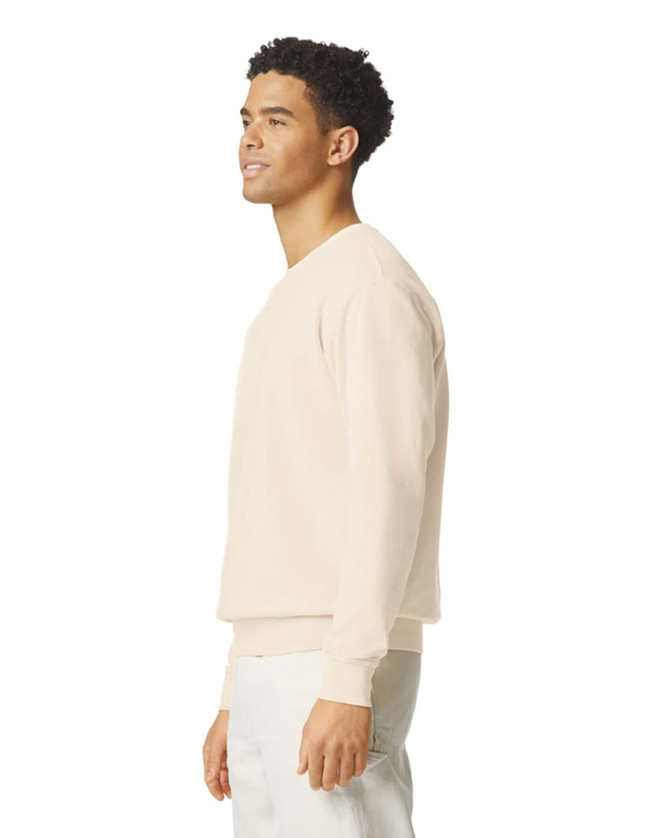 A lightweight crewneck sweatshirt in a light beige colour, displayed on a model from the side, featuring a subtle logo.