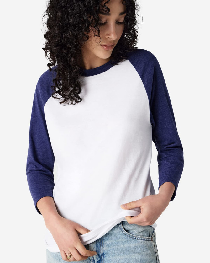 A white and navy unisex raglan T-shirt with three-quarter sleeves, featuring a logo.