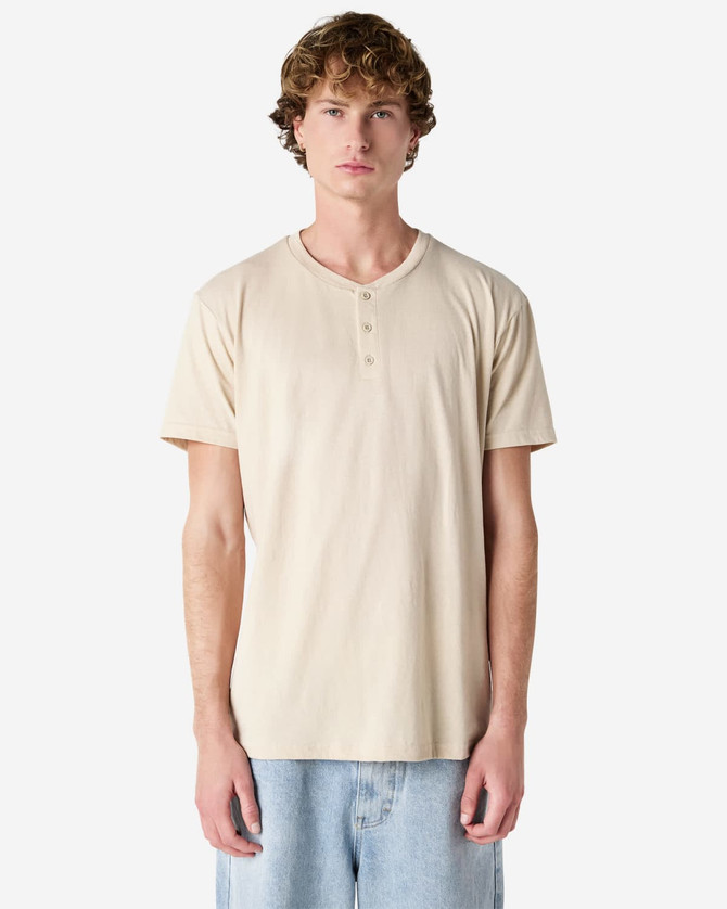 A beige unisex Henley T-shirt with short sleeves and a front placket, displayed on a male model.
