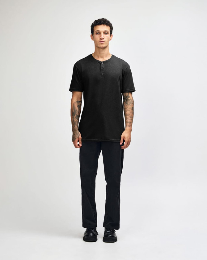 A unisex black henley T-shirt displayed on a model, featuring a buttoned neckline and short sleeves.