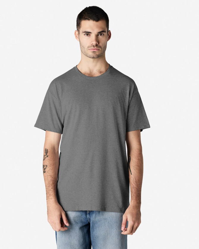 A grey Gildan Light Cotton T-Shirt displayed on a model, featuring a classic crew neck and short sleeves.