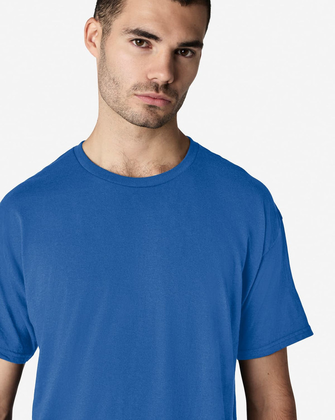 A blue Gildan Light Cotton T-Shirt on a male model, featuring a simple design and a logo.