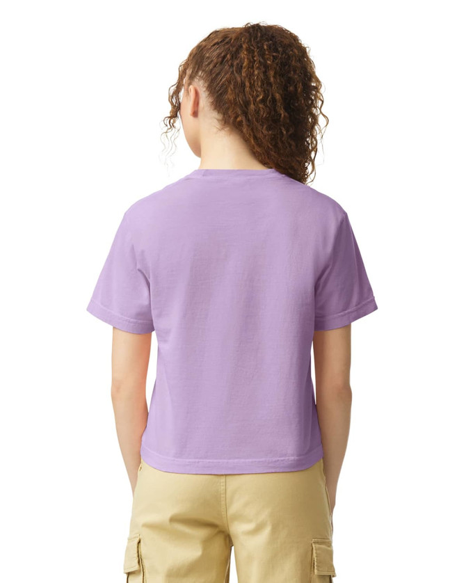 A women's heavyweight boxy T-shirt in light purple, featuring a simple design and short sleeves, with a logo.